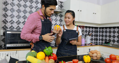 Young couple holding food at home