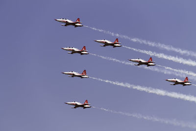 Low angle view of airshow against sky