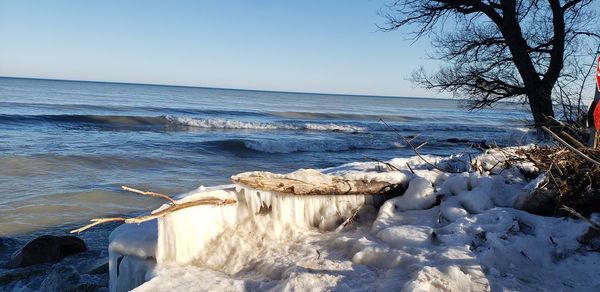 Scenic view of sea against clear sky during winter