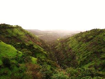 Scenic view of green mountains against sky during monsoon