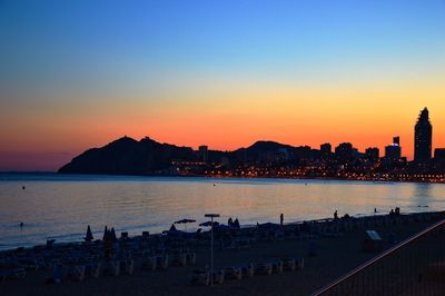 Scenic view of beach and sea against sky during sunset 