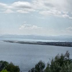 Scenic view of sea against cloudy sky