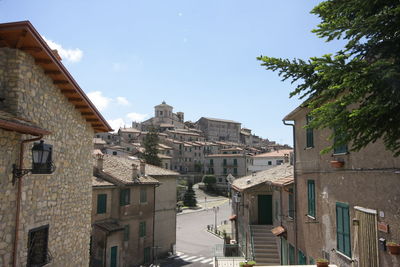 Buildings in city against sky