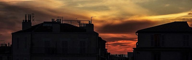 Low angle view of building against cloudy sky