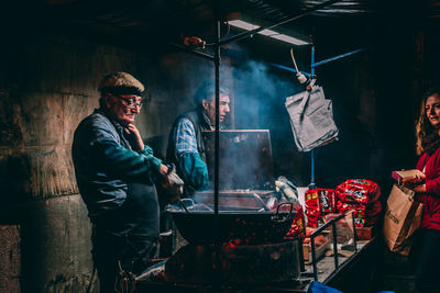 Men standing at market stall