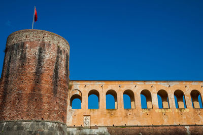 Low angle view of historical building against blue sky