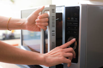 Woman using oven at home