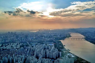 High angle view of buildings in city during sunset