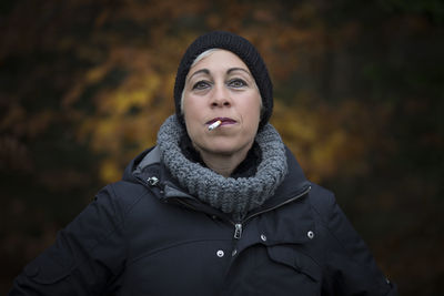 Close-up portrait of woman smoking cigarette trees