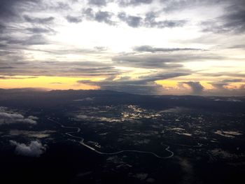 Aerial view of cityscape against cloudy sky