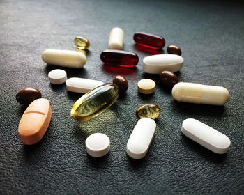 Variety of pills on leather surface