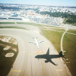 High angle view of airplane at airport runway