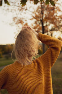 Rear view of woman standing outdoors