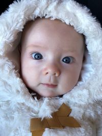 Portrait of cute baby girl in fur coat