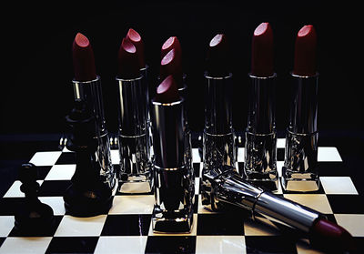 Close-up of chess board on table against black background