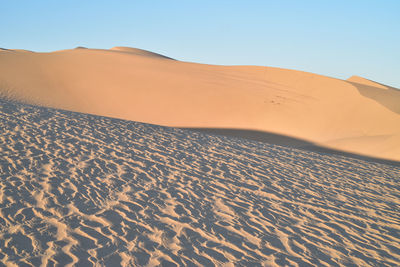 Scenic view of desert against clear sky