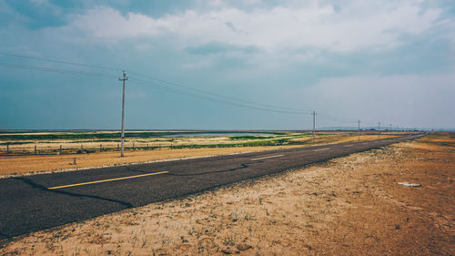 Road on field against sky