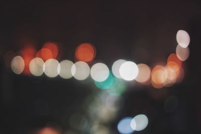 Defocused image of illuminated christmas lights at night