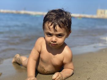 High angle view of shirtless boy at beach