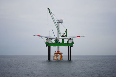 Offshore platform on sea against sky