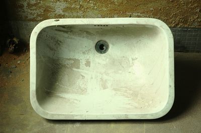 High angle view of abandoned sink by wall