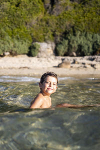 Portrait of smiling boy in water