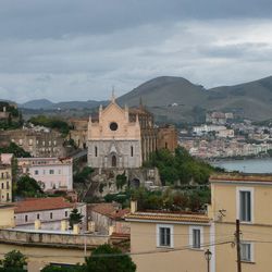 Buildings in town against sky