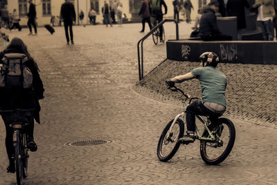 Man riding bicycle on street in city