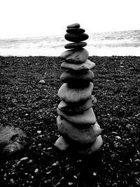 Close-up of stack of man with pebbles on beach