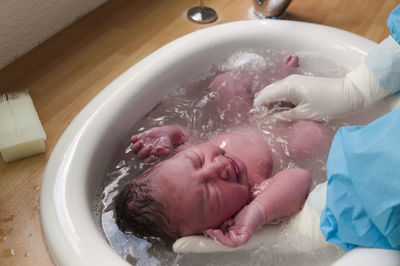 Midsection of man lying in water