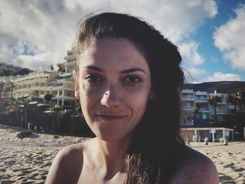 Portrait of young woman against sky