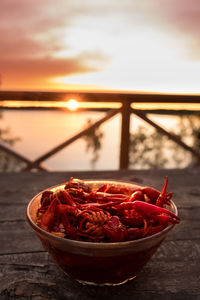 Close-up of strawberries on table against sky during sunset