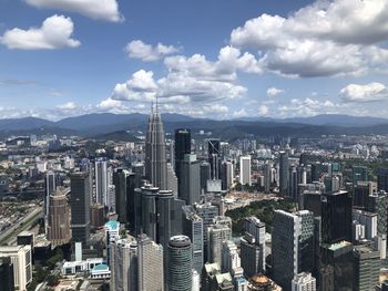 Aerial view of modern buildings in city against sky