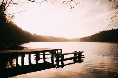 Pier over lake against sky