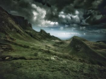 Scenic view of mountains against cloudy sky