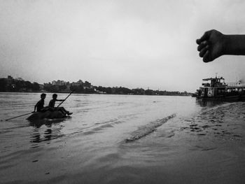 People enjoying in sea against sky