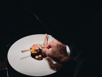 Close-up of male chef preparing food in kitchen