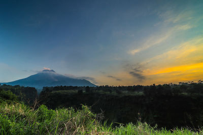 Scenic view of field against sky during sunset