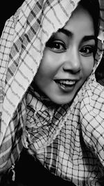 Portrait of smiling woman wearing kaffiyah