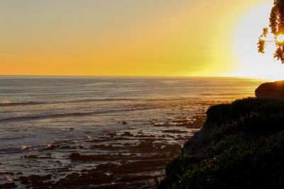 Scenic view of sea against clear sky during sunset