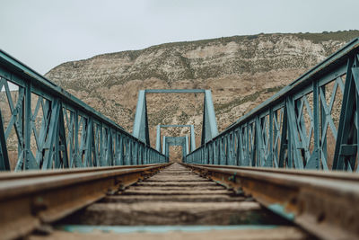 Surface level of footbridge against mountain