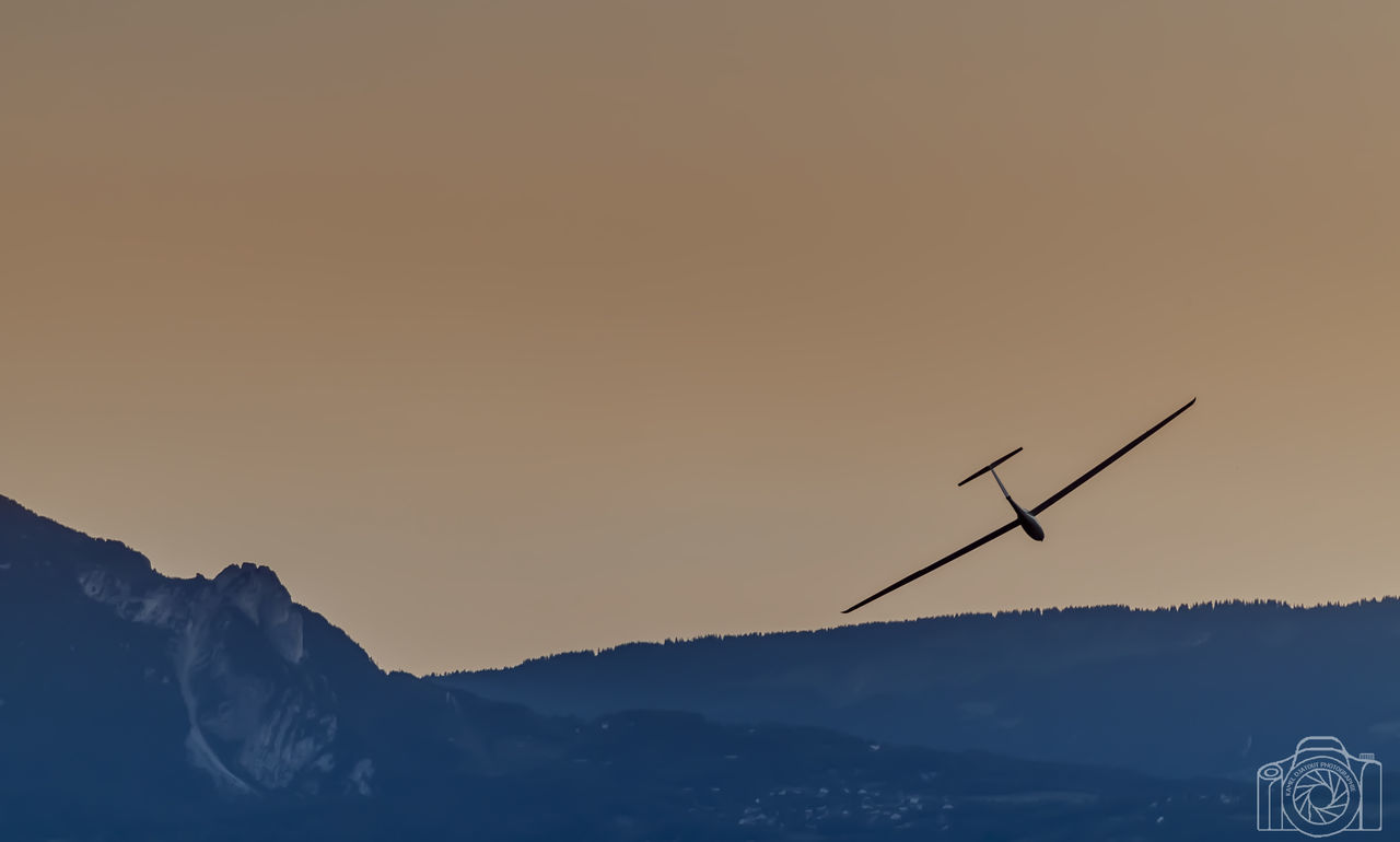 sky, sunset, scenics - nature, beauty in nature, mountain, silhouette, nature, copy space, tranquil scene, environment, tranquility, no people, orange color, clear sky, environmental conservation, non-urban scene, idyllic, outdoors, technology, mountain range