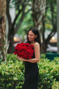 Portrait of young woman holding flower
