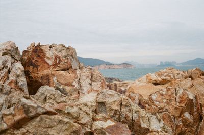 Rock formations in sea against sky