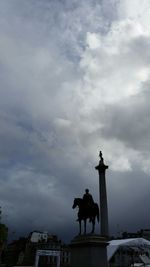 Low angle view of statue against cloudy sky