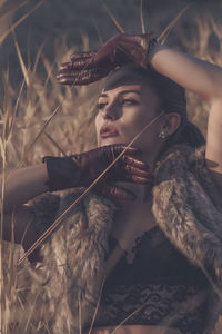 Glamourous woman posing in field