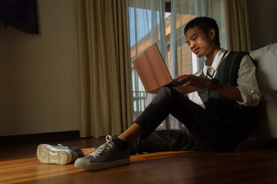 Side view of businessman using digital tablet on table