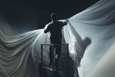 Man rehearsing with curtain at stage theater