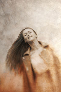 Portrait of woman against gray background