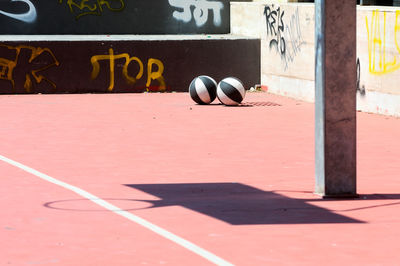 Close-up of ball on table against wall during sunny day